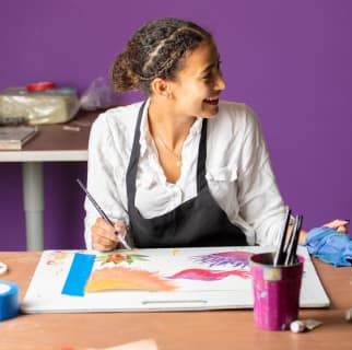 Girl painting and smiling